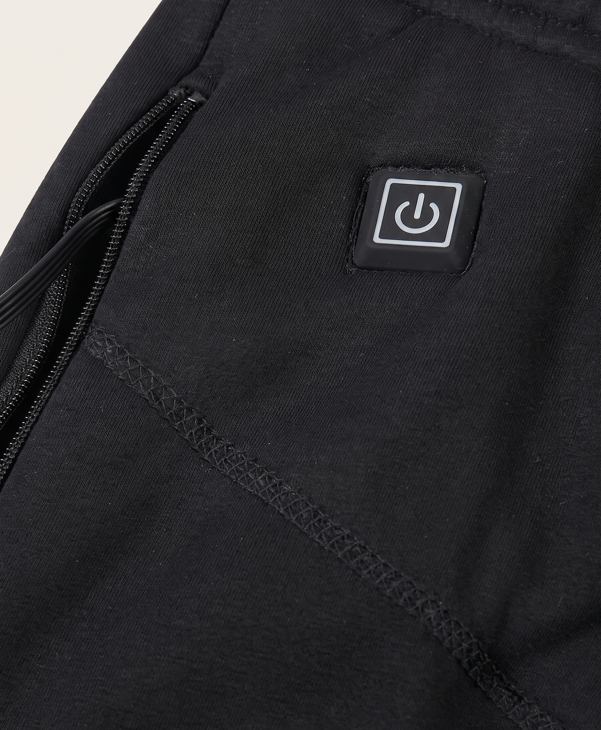 Power button patch and zip pocket with USB lead close-up