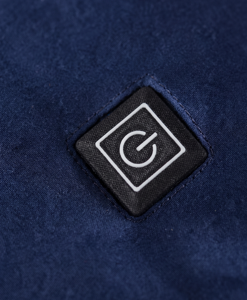 Close-up of the scarf's single power button with green, blue and red indicator lights for the three heat settings