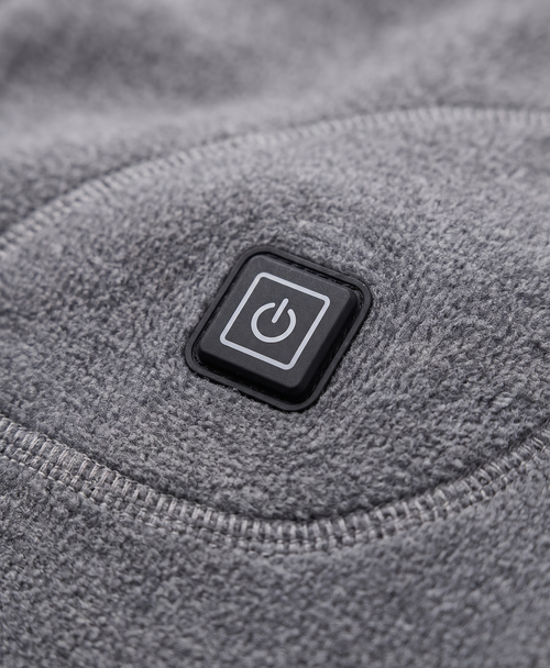 Close-up of the gray heated thermal top showing the heating icon patch at the lower side and the soft knit fabric