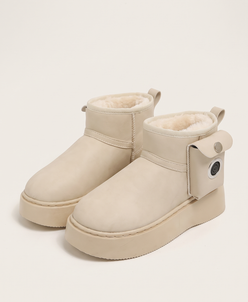 Pair of beige platform snow boots with side pockets and round power buttons, shown on their own