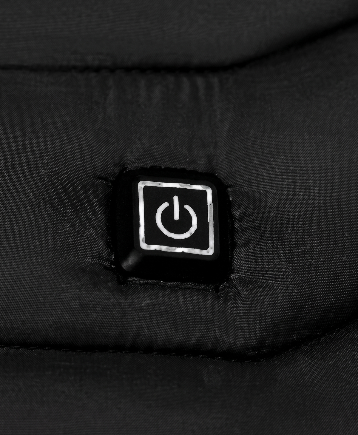 Close-up of the chest power button on the men's black heated puffer jacket