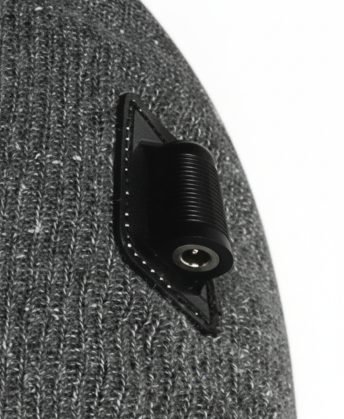 Close-up of the black connector patch and ribbed gray knit on the side of the heated beanie