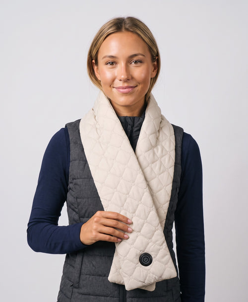 Woman wearing the Coziva heated quilted scarf in cream