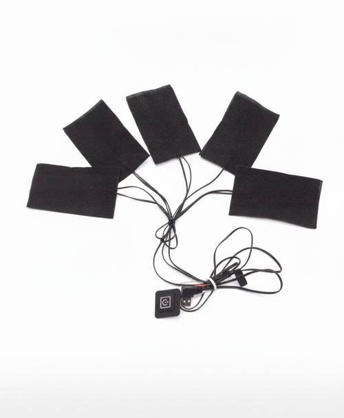 Five black heating pads with connected wires, controller button and USB plug laid out on white