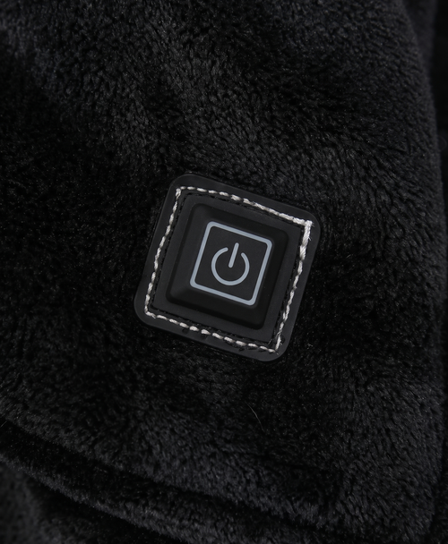 Close-up of the large front pocket and heating control button on the oversized hoodie
