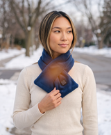 Navy blue heated scarf crossed in front with the heating element glowing and the three indicator light colors shown