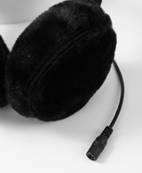 Close-up of the plush gray earmuff cups and the cable connector plugs on the heated earmuffs