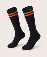 Pair of black high heated cotton socks with a striped cuff and a button on the cuff, shown on their own
