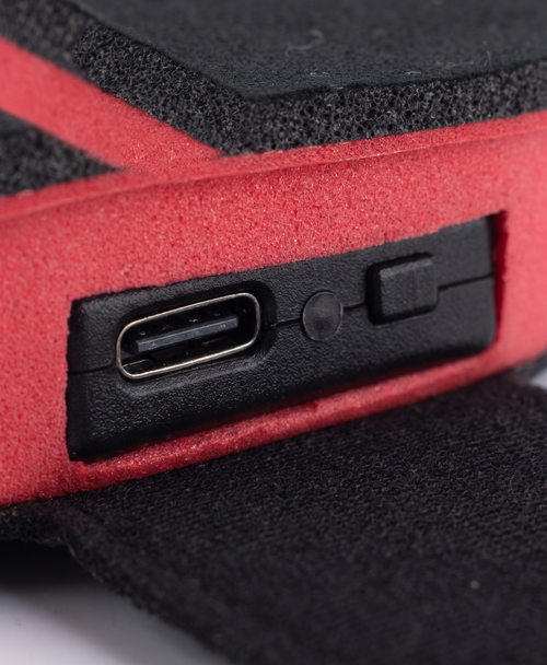 Close-up of heated insole underside with size lines, care label and heat level runtime chart
