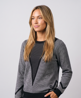 Woman wearing the women's heated knit sweater, round neck and long sleeves, studio-style photo