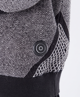 Close-up of the knitted fabric, V-shaped pattern panel and ribbed cuff of the sweater