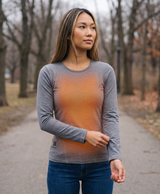 Gray women's heated thermal top in a lifestyle photo with a warm winter heat theme and plush double-layer fabric callout