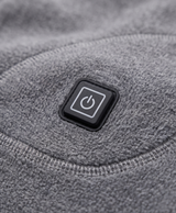 Close-up of the gray heated thermal top showing the heating icon patch at the lower side and the soft knit fabric