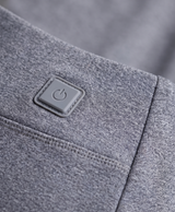 Close-up of the grey thermal pants showing the heating button patch at the hip, knee seam panel and waistband