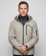 Studio photo of a man wearing the khaki men's heated hooded jacket, side view with hood up and zippered chest pocket