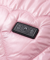 Close-up of the three-control panel on the chest and heart-pattern quilted stitching of the pink heated vest
