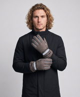 Pair of men's grey rechargeable heated gloves with adjustable wrist strap and knitted cuff, studio photo