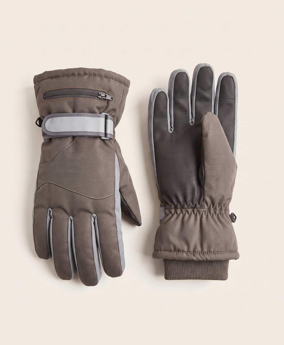 Grey rechargeable heated glove on a white background, showing the finger seams and wrist strap