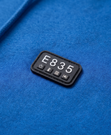 Close-up of the 4-button control panel on the chest of the sapphire blue heated hoodie