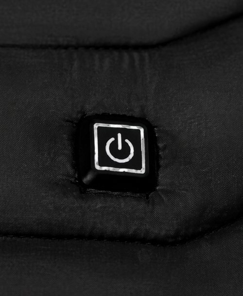 Close-up of the chest power button on the men's black heated puffer jacket