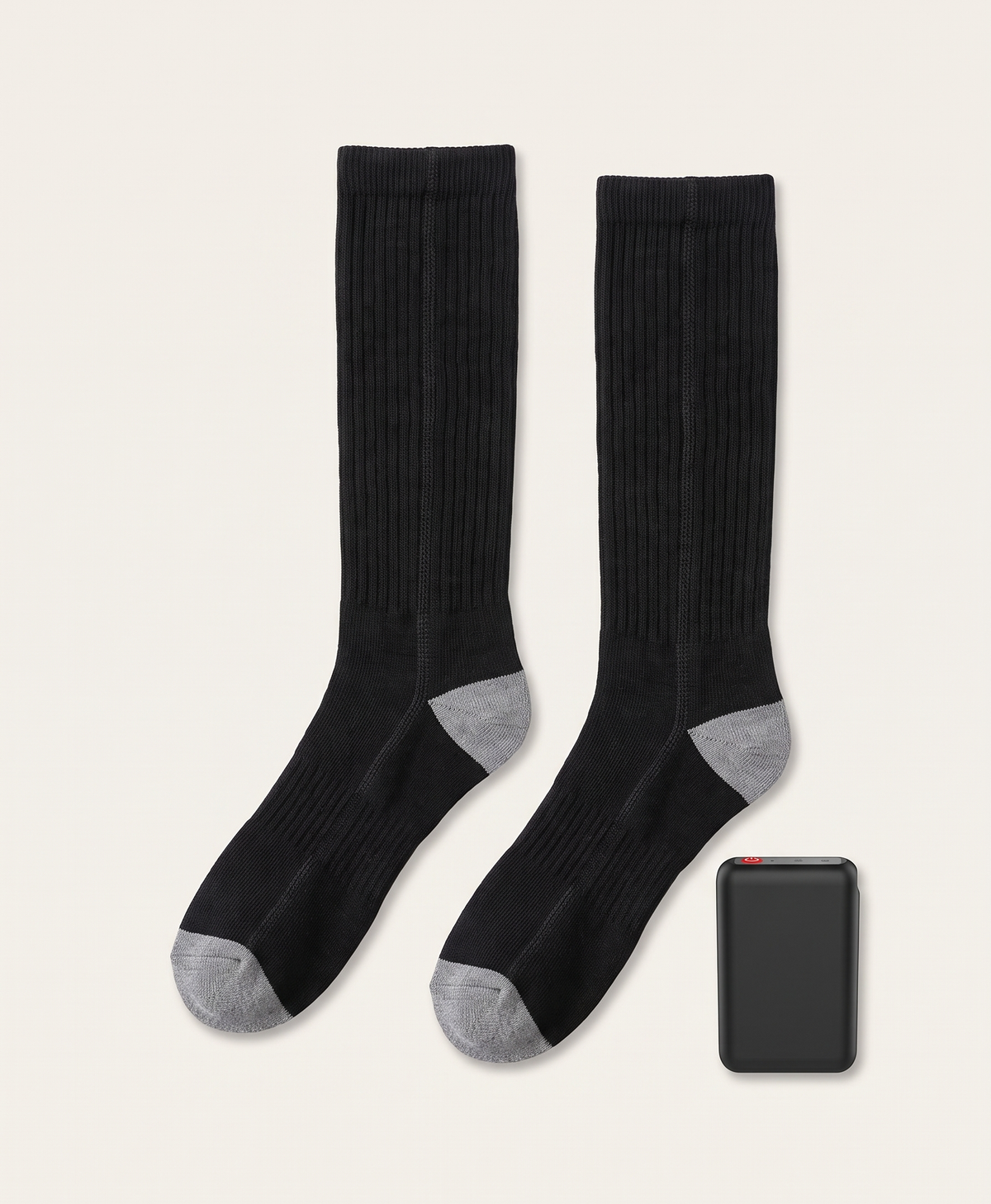 Black battery pack with red power button, shown beside the black knee-high heated socks it powers