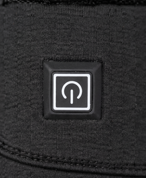 Close-up of the black glove's power button, adjustable wrist strap with buckle and quilted back of hand