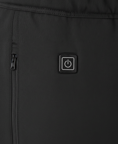 Close-up of the power button and elastic waistband on the black heated pants