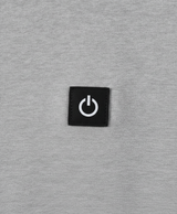 Close-up of the heated hoodie chest power button badge, drawstring hood and thick polyester fabric