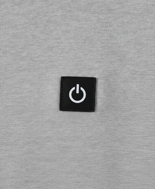 Close-up of the heated hoodie chest power button badge, drawstring hood and thick polyester fabric