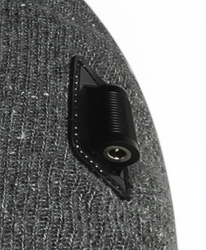 Close-up of the black connector patch and ribbed gray knit on the side of the heated beanie