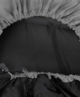 Close-up of the sleeping bag hood with adjustable drawstring and zipper, in gray with black lining