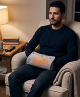 Gray heated hand muff with black USB cable, shown wrapped around a forearm and draped across the shoulders and lap