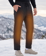 Black 12-zone heated pants shown with heating panel diagram on the waist, thighs and legs, plus a man and woman wearing them