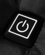Close-up of the chest power button and front zip on the black heated puffer jacket