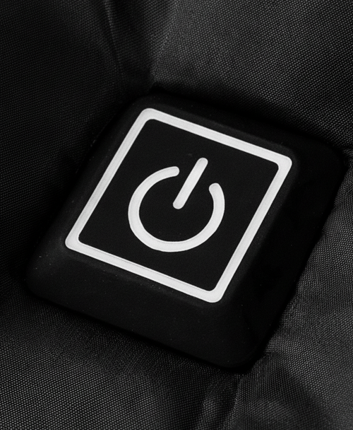 Close-up of the chest power button and front zip on the black heated puffer jacket